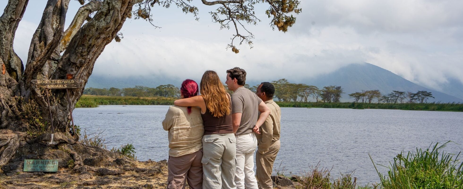 Four people looking at nature arm in arm